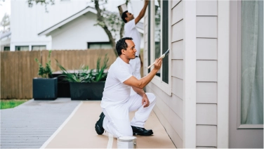 Painting trim on a home.